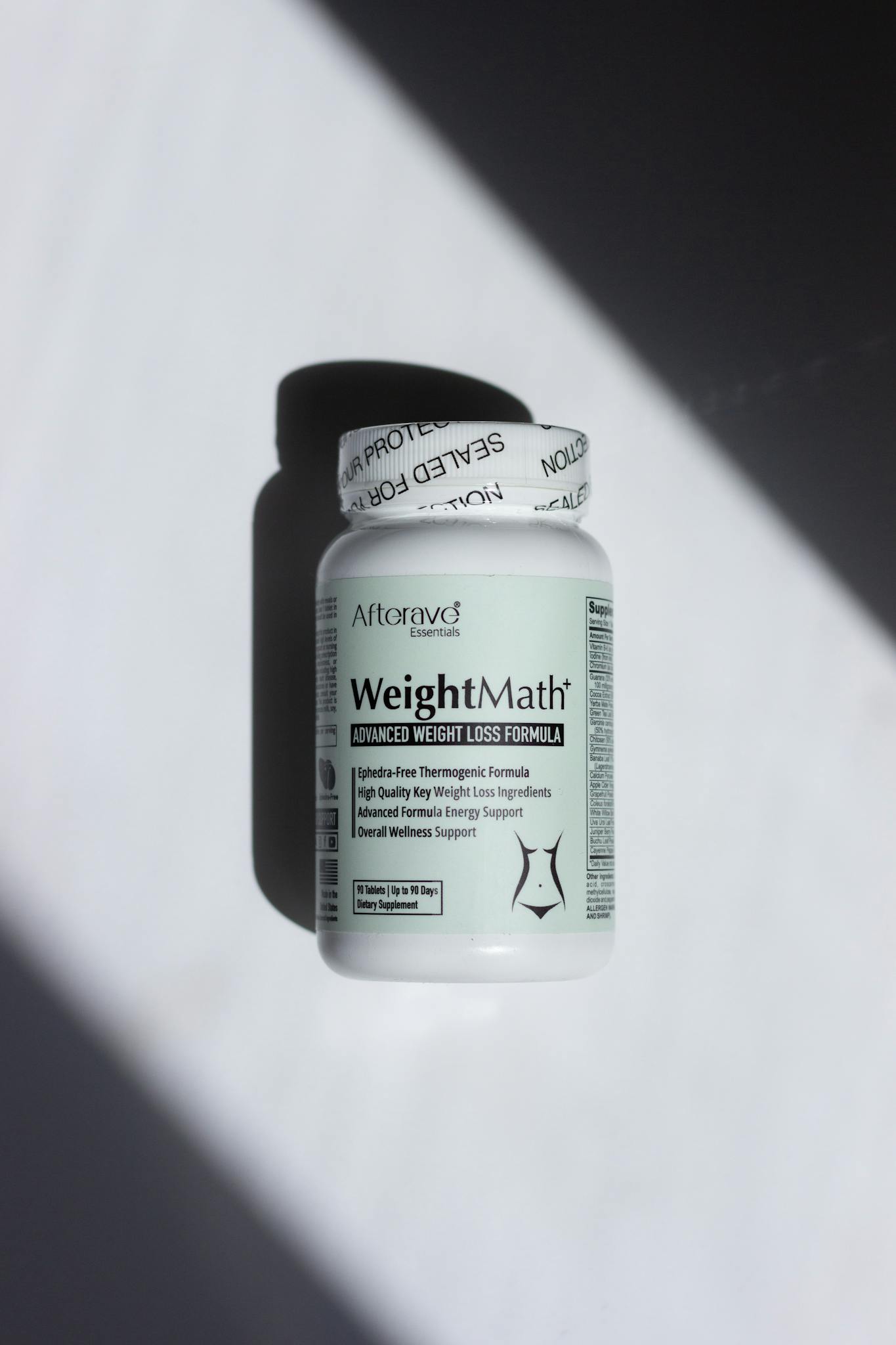 A bottle of Afterave WeightMath advanced weight loss formula placed on a minimalist surface in bright lighting.