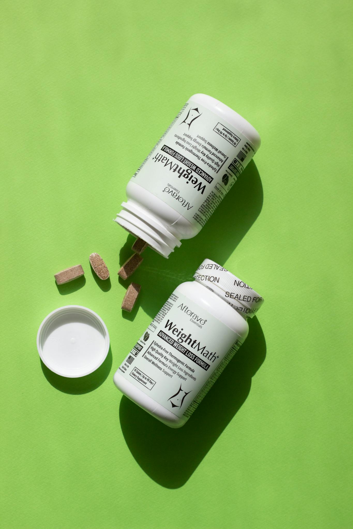 Weight management vitamin bottles with tablets on a vibrant green background for healthy living.